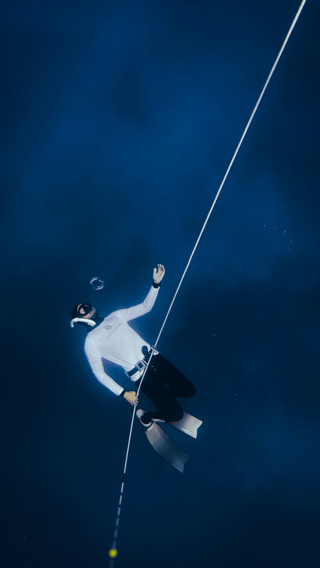 Freediver descending along the line
